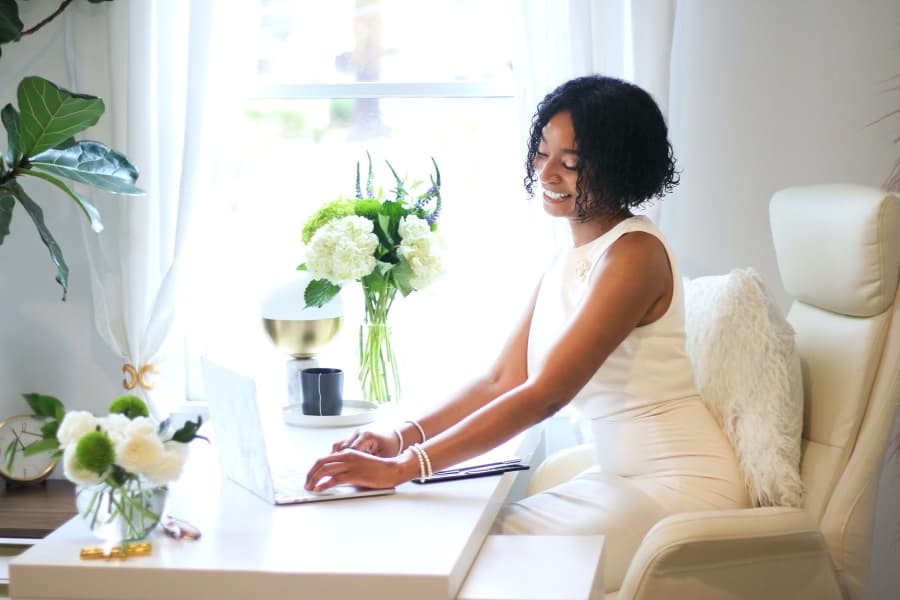 Dr. Iman Hypolite, psychiatrist and therapist for high-achieving women, working at her desk.